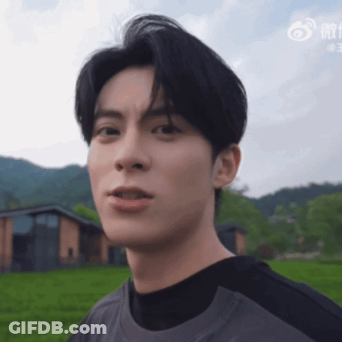 Close Up Of Man's Face With Chinese Writing GIF