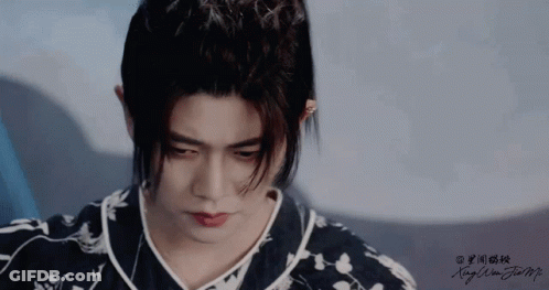 Close Up Of Man's Face With Chinese Writing GIF
