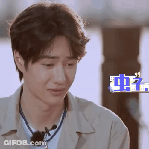 Close Up Of Man's Face With Chinese Writing GIF