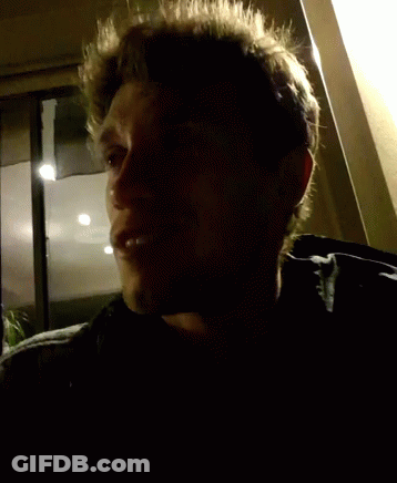 Close Up Of Man's Face With Dark Background GIF