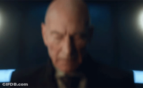 Close Up Of Man's Face With Dark Background GIF