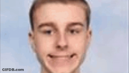 Close Up Of Man's Face With Green Object In Mouth GIF