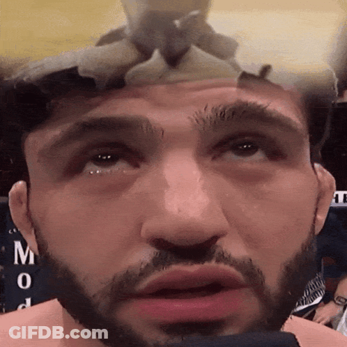 Close Up Of Man's Face With Letter M GIF