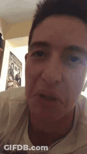 Close Up Of Man's Face With Poster GIF