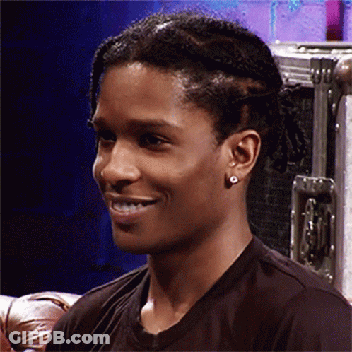 Close Up Of Man Wearing Earrings And Braided Hair GIF