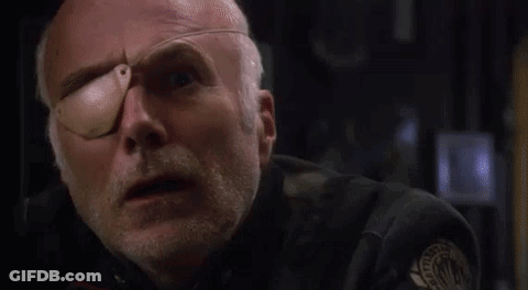 Close Up Of Man With Bandage On Eye Saying What The Frak GIF