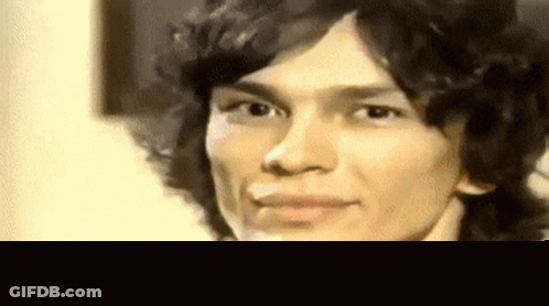 Close Up Of Man With Curly Hair And Cigarette GIF