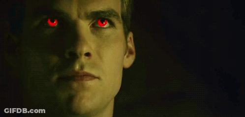 Close Up Of Man With Red Eyes In The Dark GIF