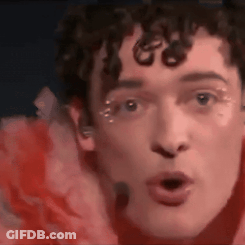 Close Up Of Man With Red Flower GIF