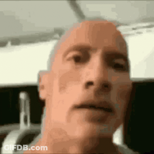 Close Up Of Man With Shaved Head Looking At Camera GIF