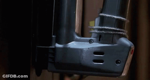 Close Up Of Nail Gun On Wall GIF