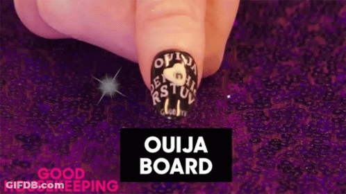 Close Up Of Nails With Ouija Board GIF