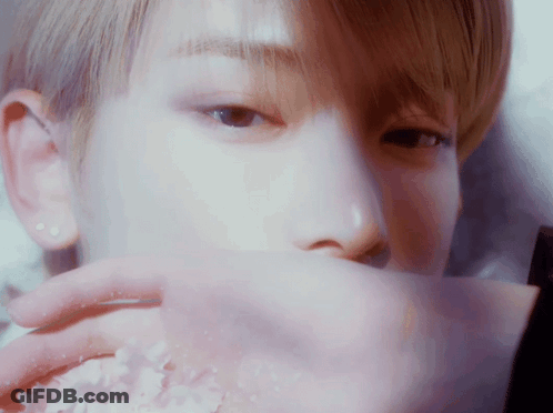 Close Up Of Person Covering Mouth With Paper GIF
