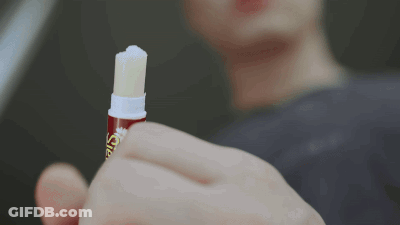 Close Up Of Person Holding Lip Balm Saying Lip Balm GIF