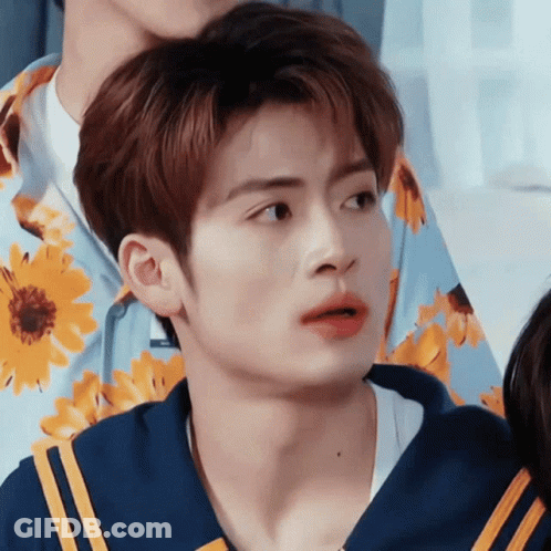 Close Up Of Person In Blue Shirt With Yellow Flowers GIF