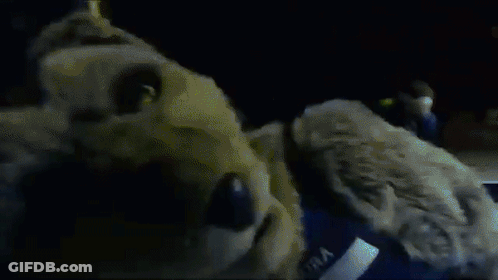 Close Up Of Person In Dark Room With Sign Saying T GIF