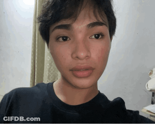 Close Up Of Person's Face In Black Shirt GIF