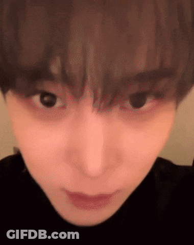 Close Up Of Person's Face In Black Turtleneck GIF