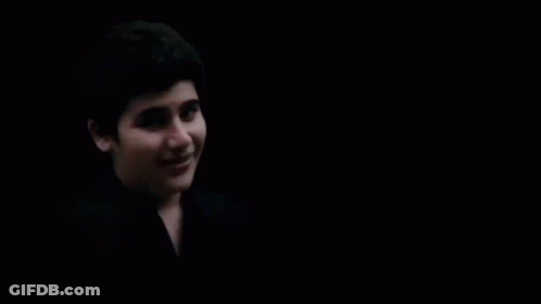 Close Up Of Person's Face In Darkness GIF