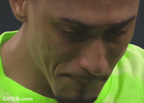 Close Up Of Person's Face In Green Shirt GIF