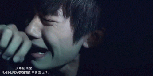 Close Up Of Person's Face With Chinese Writing GIF