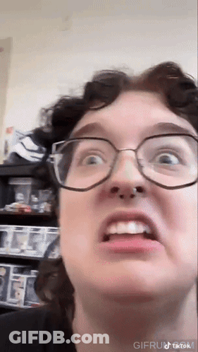 Close Up Of Person Wearing Glasses Making Face GIF