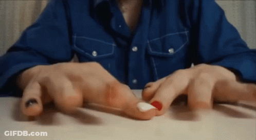 Close Up Of Red And White Nails GIF