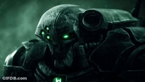Close Up Of Robot With Green Eyes And Letter T On Chest GIF