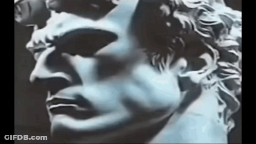 Close Up Of Statue Man Face On Black Background GIF