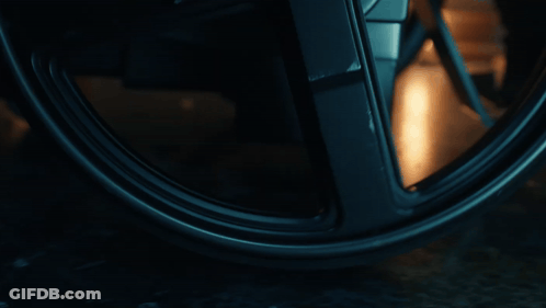 Close Up Of Wheel With Person Reflection GIF
