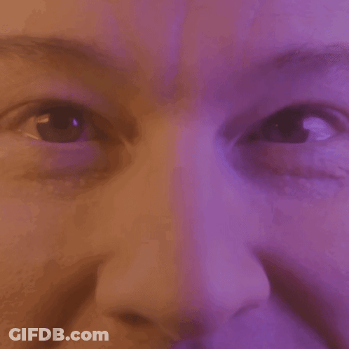 Close Up Of Woman Eyes And Nose Purple Background GIF