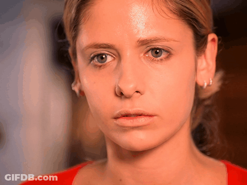 Close Up Of Woman Face With Red Shirt And Earrings GIF
