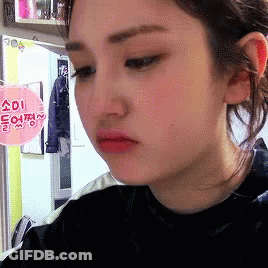 Close-Up Of Woman Face With Sign Saying Adi GIF