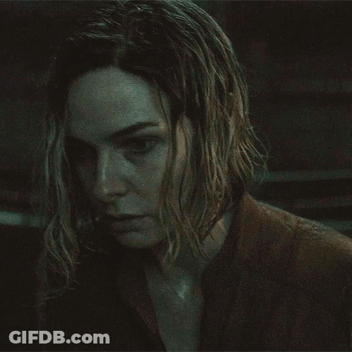 Close Up Of Woman's Face In Dark Room GIF