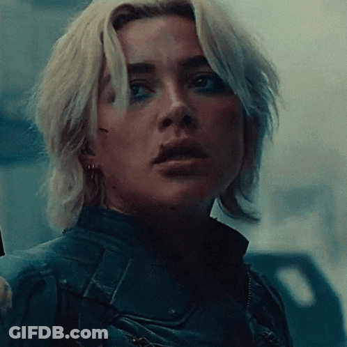 Close Up Of Woman's Face In Dark Room GIF