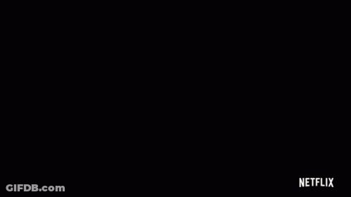 Close Up Of Woman's Face In Dark Room With Netflix Logo GIF