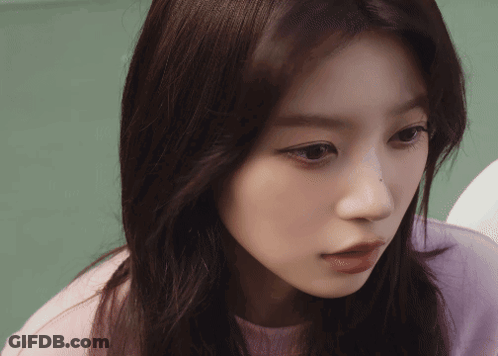 Close-Up Of Woman's Face In Purple Sweater GIF