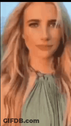 Close Up Of Woman's Face With Blonde Hair And Green Top GIF