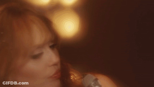 Close Up Of Woman's Face With Blurry Lights Background GIF