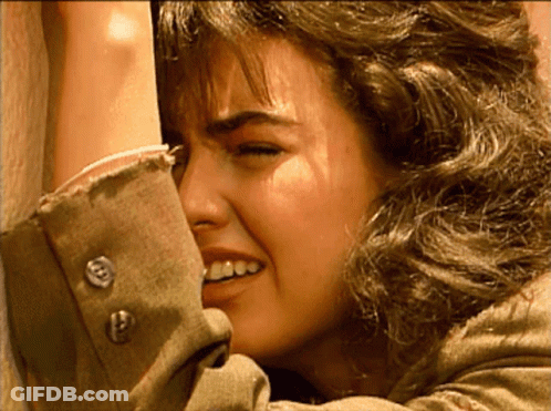 Close Up Of Woman's Face With Buttons On Sleeve GIF