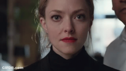 Close Up Of Woman's Face With Man In Background GIF