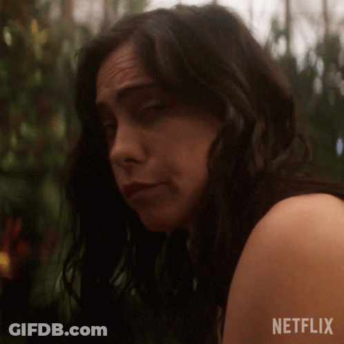Close Up Of Woman's Face With Netflix Logo Behind Her GIF