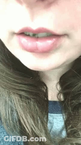 Close Up Of Woman's Lips With Gray Shirt GIF