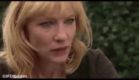 Close Up Of Woman With Blonde Hair And Blue Eyes Looking At Camera GIF