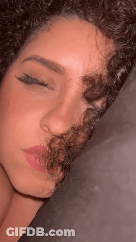 Close Up Of Woman With Curly Hair And Pink Lips GIF