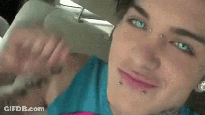 Close Up Of Woman With Face Piercings And Arm Tattoo GIF