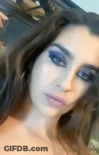 Close-Up Of Woman With Purple Eye Makeup GIF
