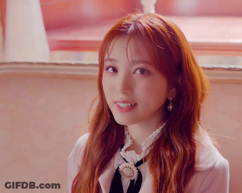 Close Up Of Woman With Red Hair And Earrings GIF