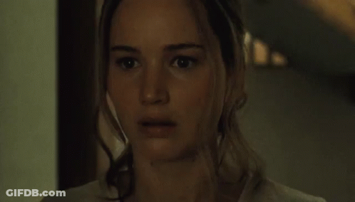 Close Up Of Woman With Serious Look In Dark Room GIF
