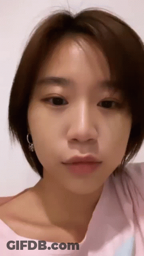 Close-Up Of Woman With Short Brown Hair And Earrings GIF